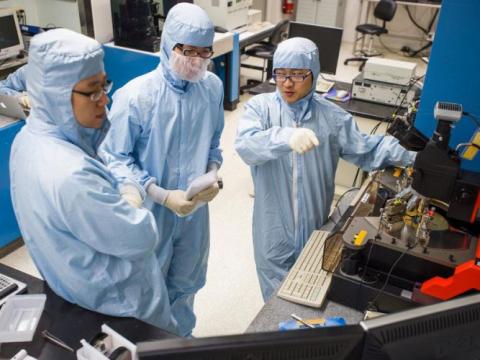 Three researchers collaborate in the RPI Cleanroom